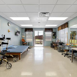 A well-equipped therapy room in a healthcare facility, designed for rehabilitation and physical therapy sessions.
