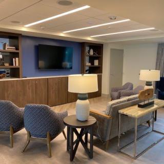 A modern living room with comfortable seating, a large television, and stylish decor.