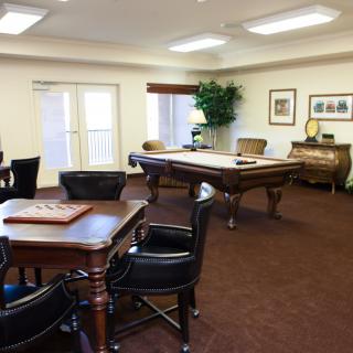A cozy game room featuring a pool table and seating for board games.