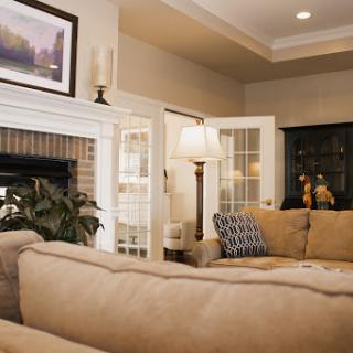 A cozy living room featuring a comfortable sofa, stylish lamp, and decorative artwork.