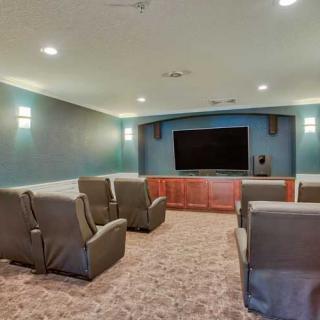A cozy home theater with comfortable seating and a large screen.
