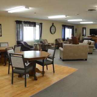 A cozy lounge area featuring tables, chairs, and sofas, designed for relaxation and social interaction.