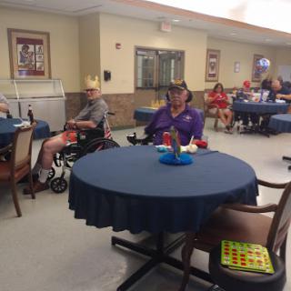 A lively community activity room filled with seniors enjoying their time together.
