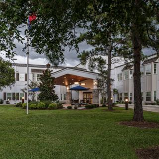 A scenic view of a building surrounded by trees and greenery.