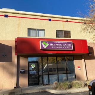 A storefront displaying a business sign in a commercial area.