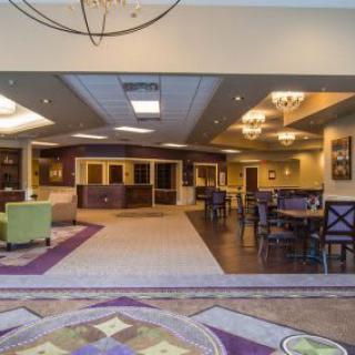 A spacious lobby area with modern furniture and a reception desk.