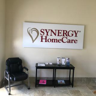 A welcoming reception area for Synergy HomeCare, featuring a comfortable chair and informational materials.