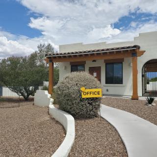 A welcoming office with a distinct landscaping design in a desert setting.