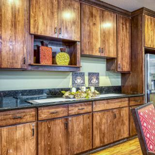 A vintage-style kitchen with wooden cabinets and decorative accents.