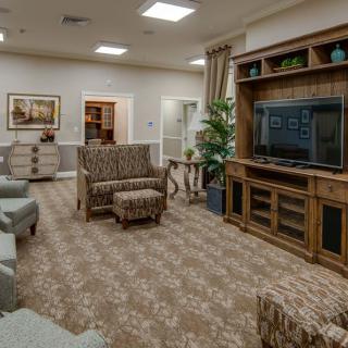 A cozy living room with comfortable seating and a large entertainment center.