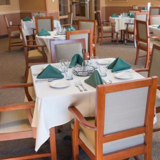 A neatly arranged dining area with tables set for guests.