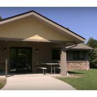 A suburban house with a covered porch and a brick exterior.