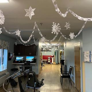 A winter-themed decoration featuring snowflakes and paper chains hanging in a hallway of a medical facility.