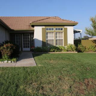 A suburban house with a well-maintained lawn and garden.