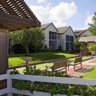 A peaceful residential area featuring well-maintained gardens and inviting benches for relaxation.