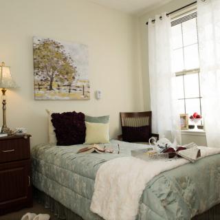 A cozy bedroom with soft lighting and inviting decor.
