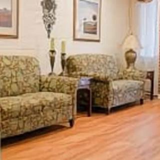 A cozy living room with patterned sofas and tasteful decor.