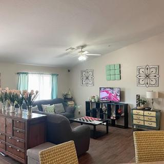 A cozy and stylish living room featuring a comfortable sofa, decorative elements, and a television.