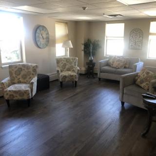 A cozy living room space with comfortable seating and ample natural light.