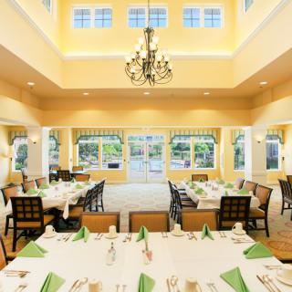 A beautifully arranged dining room with elegant decor and bright lighting.