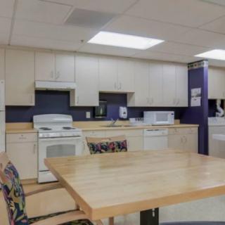 A well-equipped kitchen with modern appliances and a wooden table.