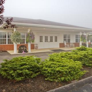 A single-story building with a landscaped exterior and covered entrance.