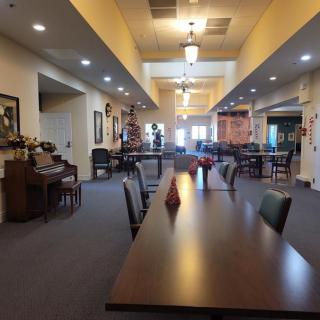 A spacious dining area with long tables and ambient lighting.