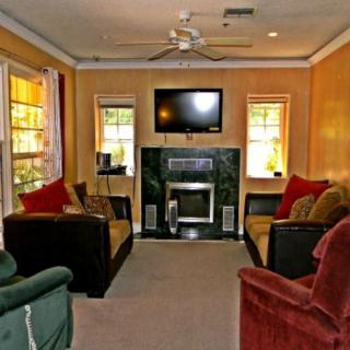 Cozy living room featuring a fireplace, television, and comfortable seating.