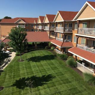 A picturesque hotel with a well-maintained lawn and inviting balconies.