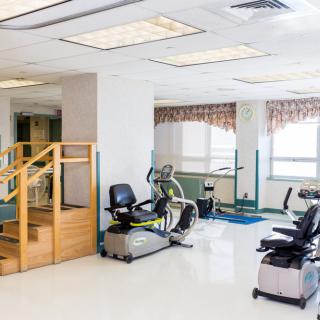 A rehabilitation center with various exercise equipment for physical therapy.