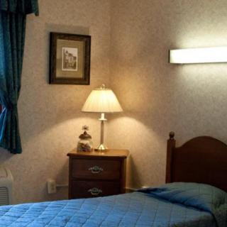 Cozy bedroom with a single bed and warm lighting.