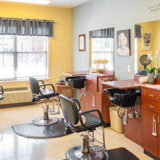 A modern hair salon featuring stylish barber chairs and a welcoming atmosphere.