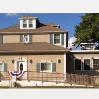 A charming two-story home with a welcoming entrance and decorative accents.