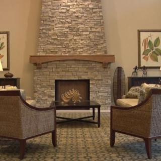 Cozy living room with a stone fireplace and comfortable seating.