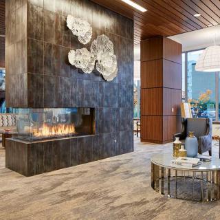 A modern lobby with a sleek fireplace and stylish seating area.