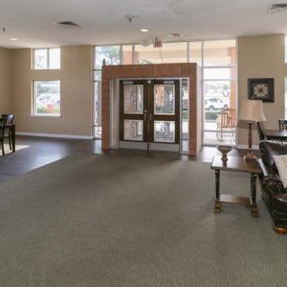 A spacious lobby with glass entrance doors and comfortable seating.