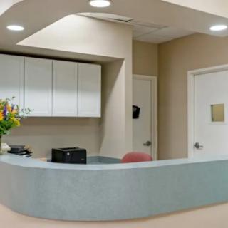 A clean and modern reception desk in a medical office setting.