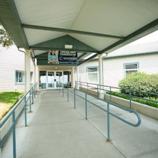 A welcoming entrance with a ramp leading to the building, providing accessibility.