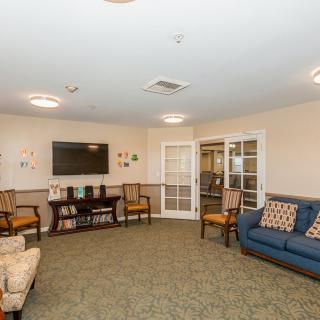 A cozy living room with comfortable seating and a television, designed for relaxation.