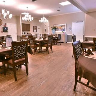 A cozy dining area with wooden floors and elegant lighting.