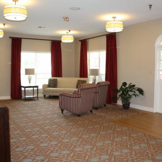 A cozy living room with comfortable seating, elegant curtains, and soft lighting.