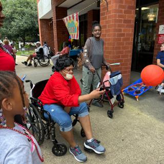 A vibrant community gathering where individuals of all ages come together to share smiles and experiences.