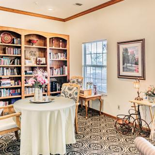 A cozy library with bookshelves and a comfortable seating area.
