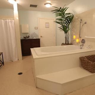 A serene and modern spa-like bathroom with a large bathtub, perfect for relaxation.
