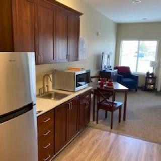 Modern apartment interior with kitchen and living area.