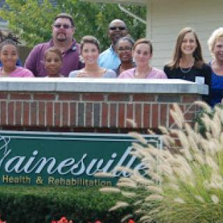 A group of individuals gathered outside a rehabilitation center, showcasing a sense of community and care.