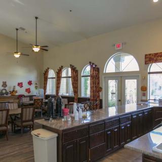 A spacious kitchen and dining area with large windows and decorative elements.