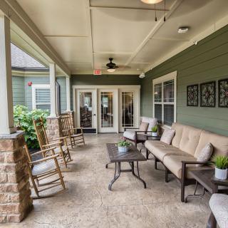 Cozy porch with seating area and decor elements.