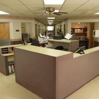 A reception desk in an office setting, featuring a well-organized workspace.