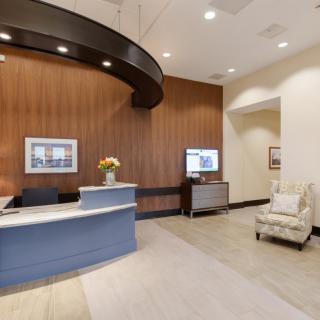 A modern office reception area with a stylish desk and comfortable seating.
